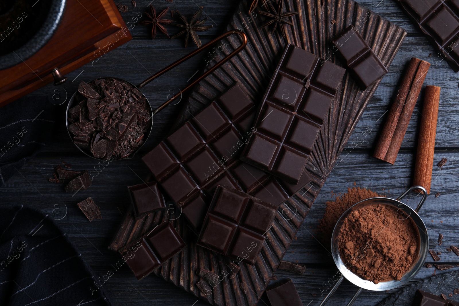 Photo of Flat lay composition with dark chocolate on black wooden table