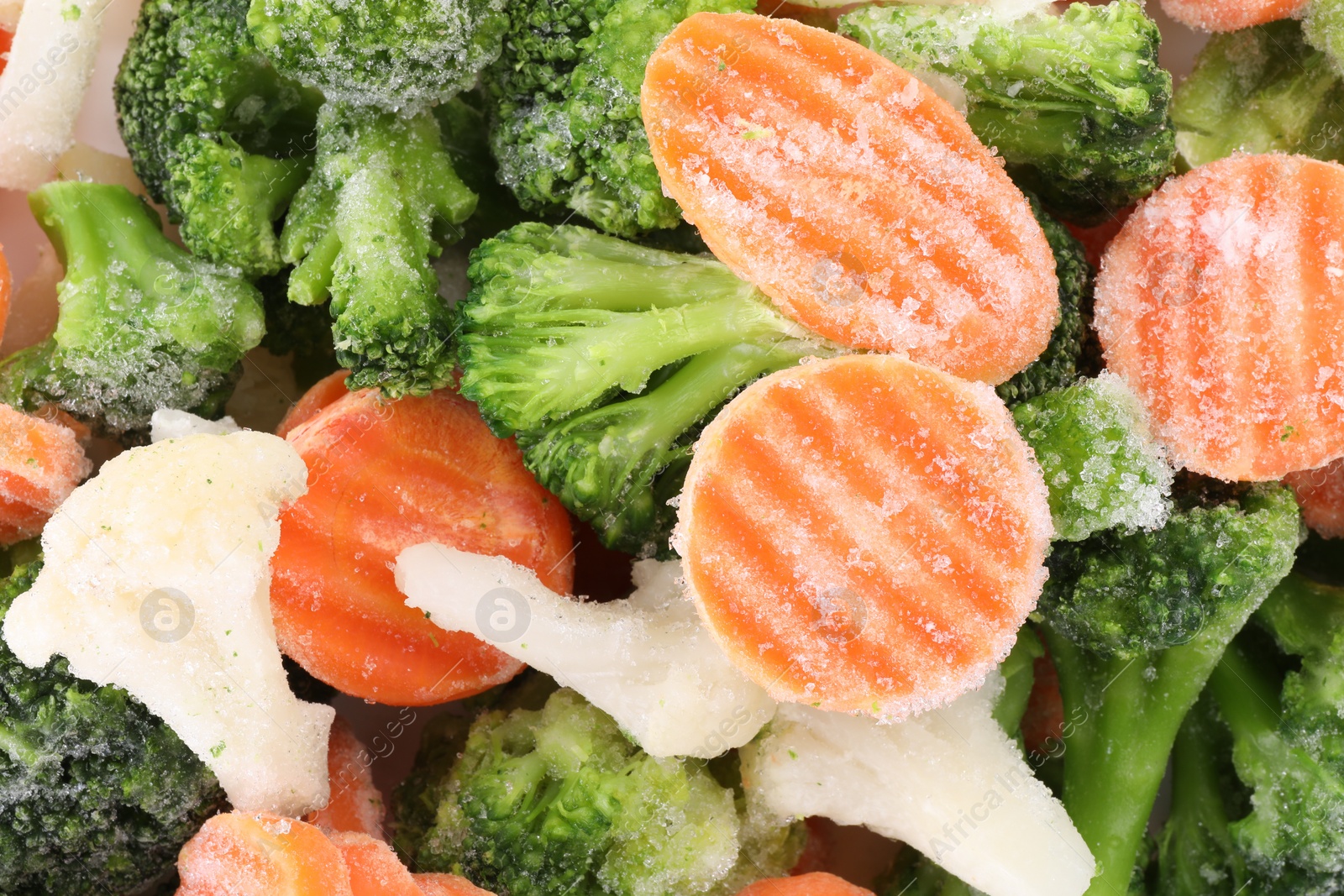 Photo of Mix of different frozen vegetables as background, top view