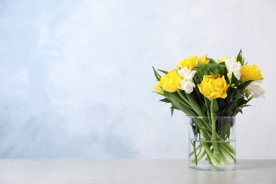 Photo of Beautiful bouquet with peony tulips on table against light blue background, space for text