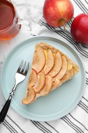 Freshly baked delicious apple pie served on white marble table, flat lay