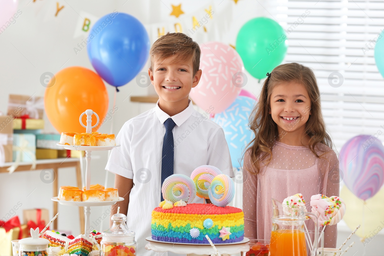 Photo of Happy children at birthday party in decorated room