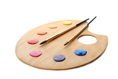Photo of Palette with paints and brushes on white background