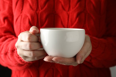 Photo of Woman holding cup of hot winter drink, closeup
