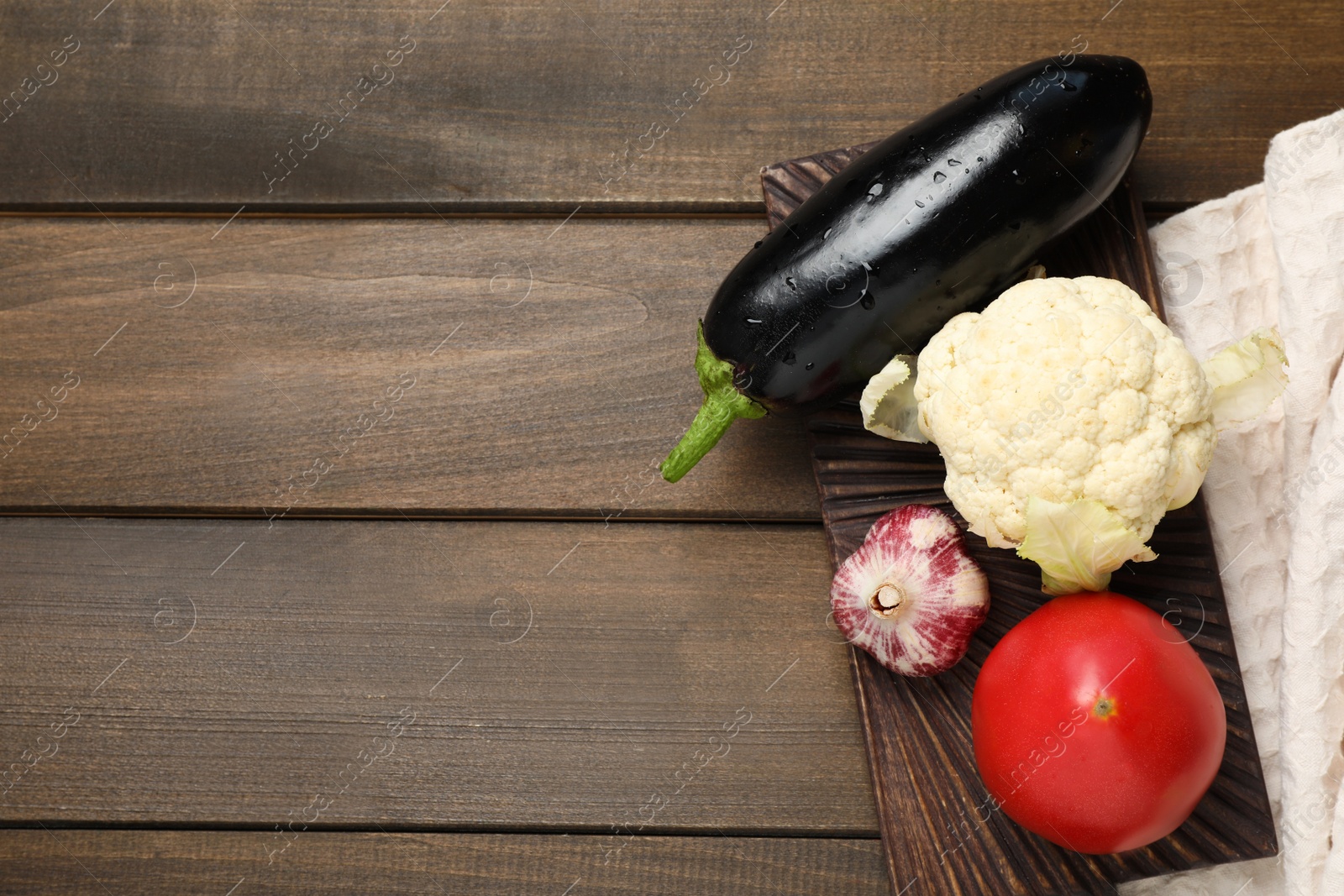 Photo of Many different vegetables on wooden table, top view. Space for text