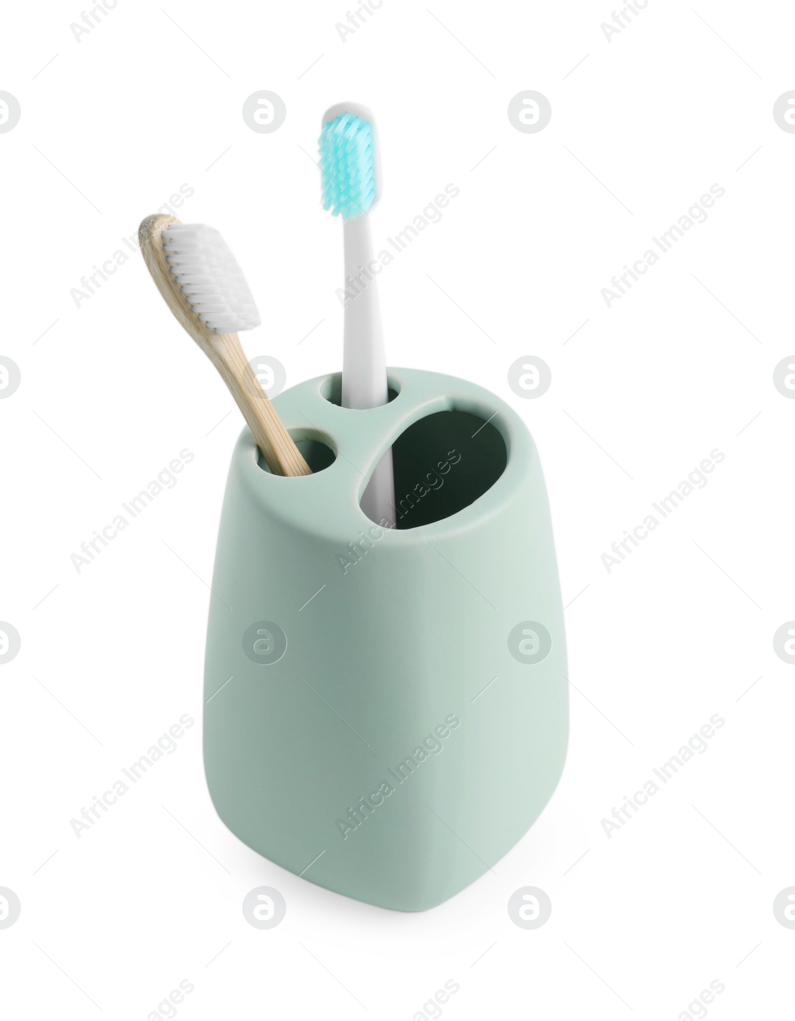 Photo of Bath accessory. Ceramic holder with toothbrushes isolated on white