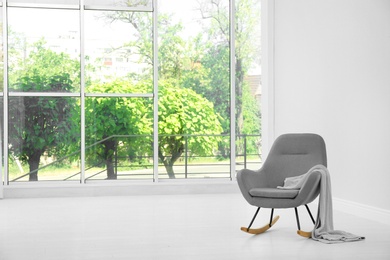 Living room interior with comfortable rocking chair near window