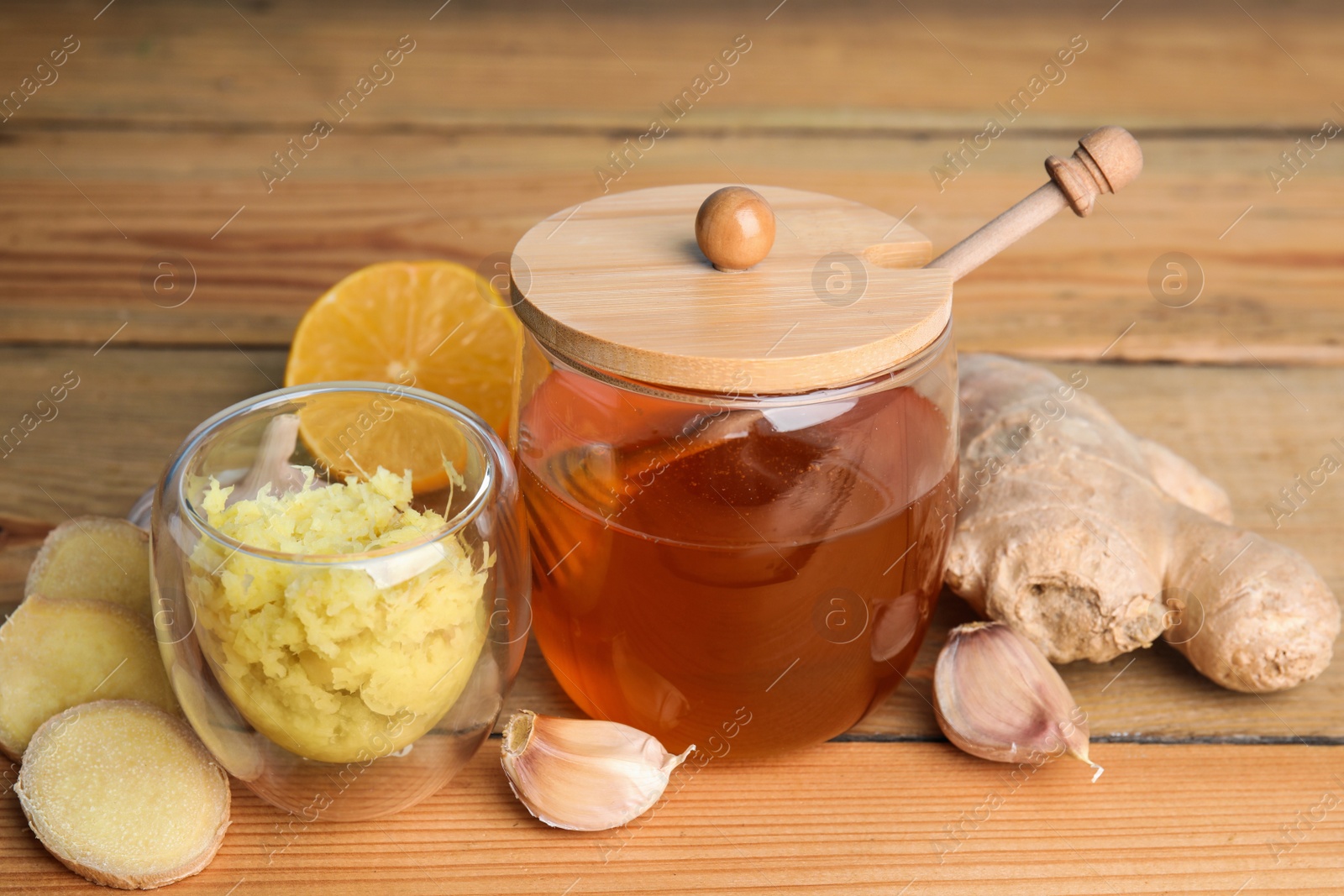 Photo of Fresh garlic and other natural cold remedies on wooden table