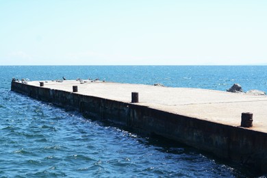 Photo of Beautiful concrete pier in sea on sunny day