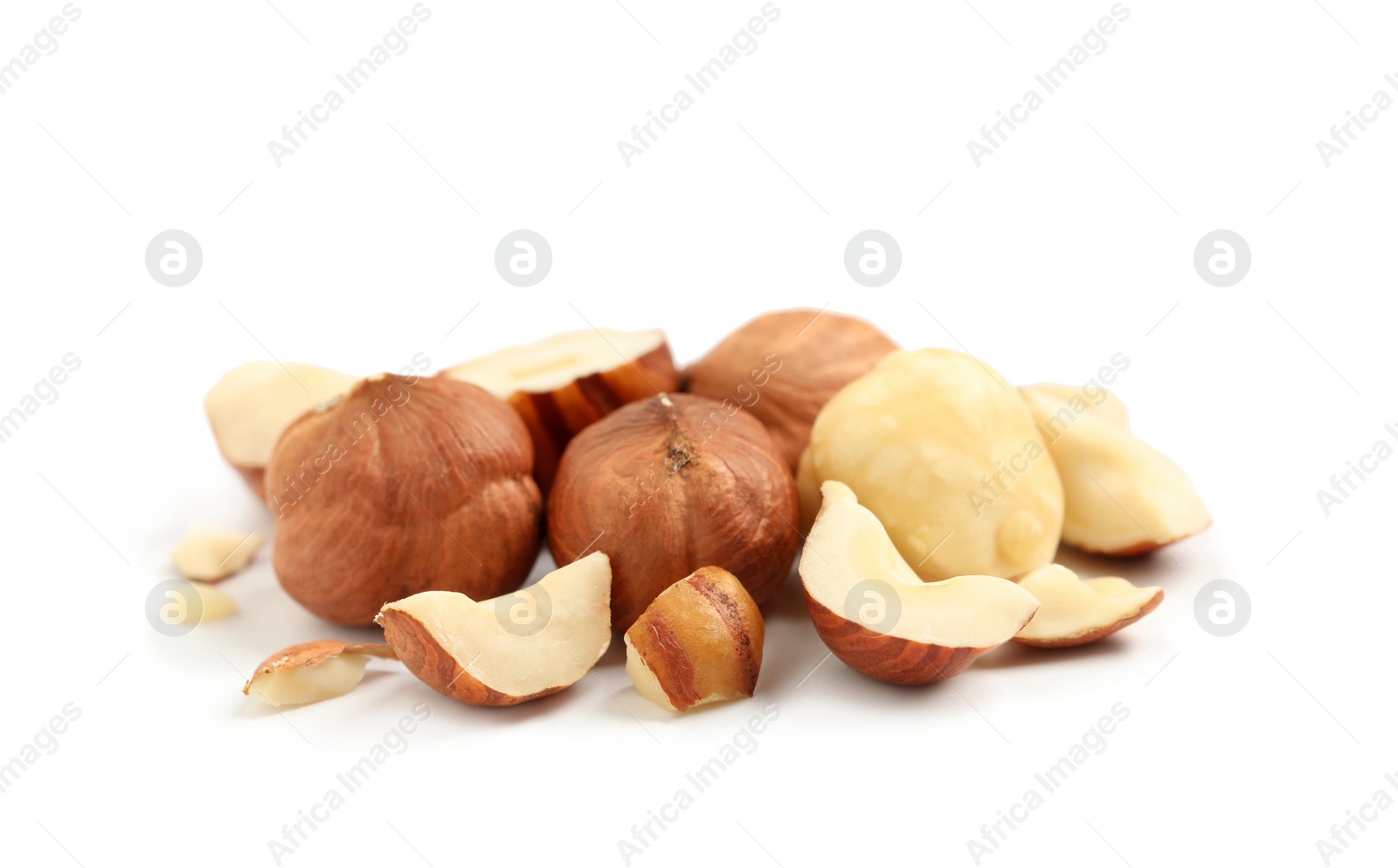 Photo of Heap of tasty hazelnuts on white background