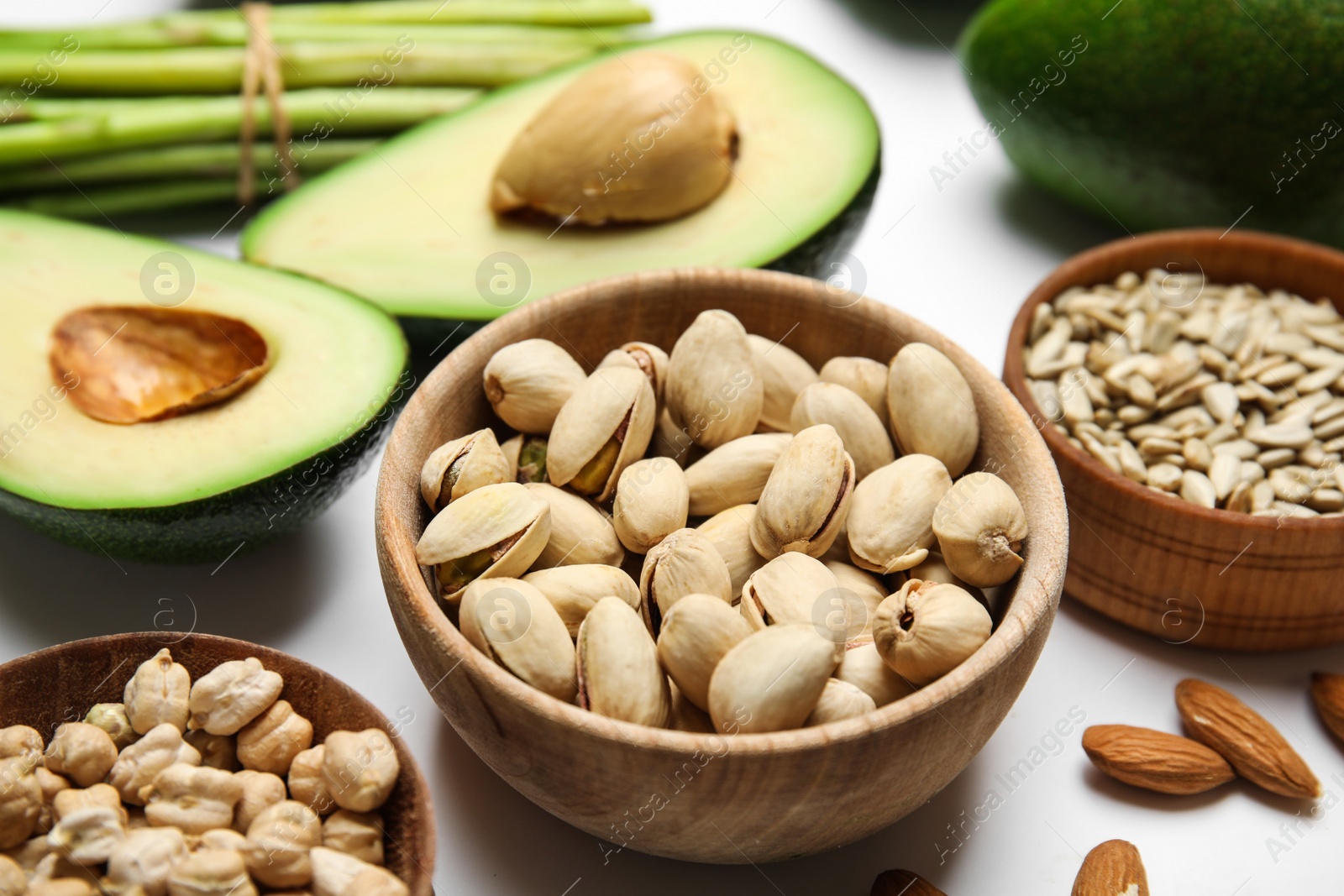 Photo of Different products rich in vitamin E on white background, closeup