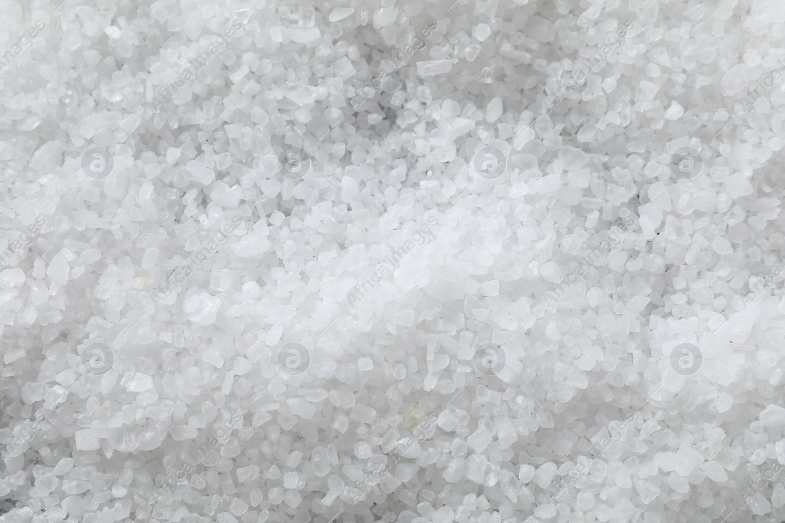 Photo of White natural salt as background, top view