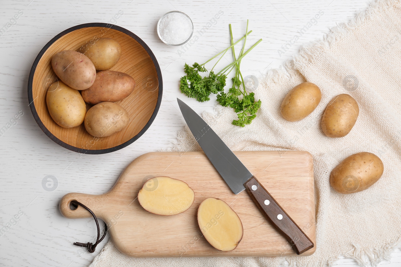 Photo of Flat lay composition with fresh ripe organic potatoes on white wooden background