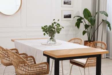 Stylish dining room with cozy furniture and plants