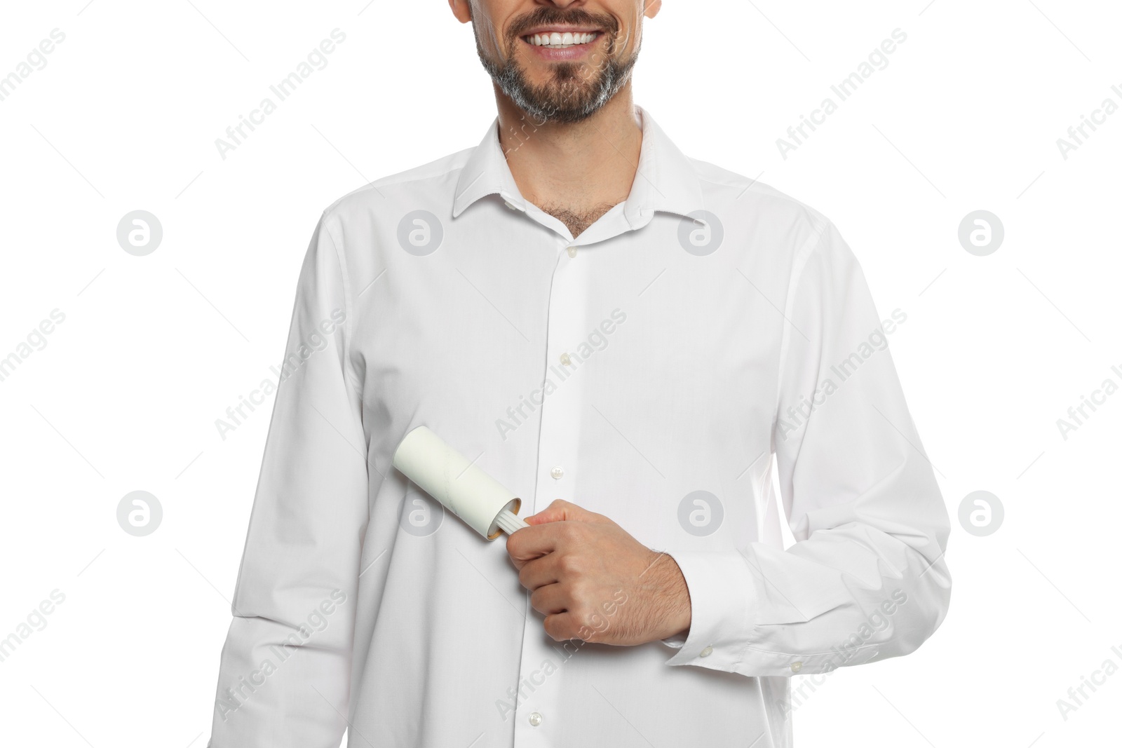 Photo of Man cleaning shirt with adhesive lint roller on white background, closeup