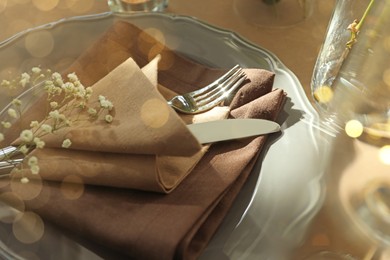 Photo of Festive table setting with beautiful tableware and floral decor