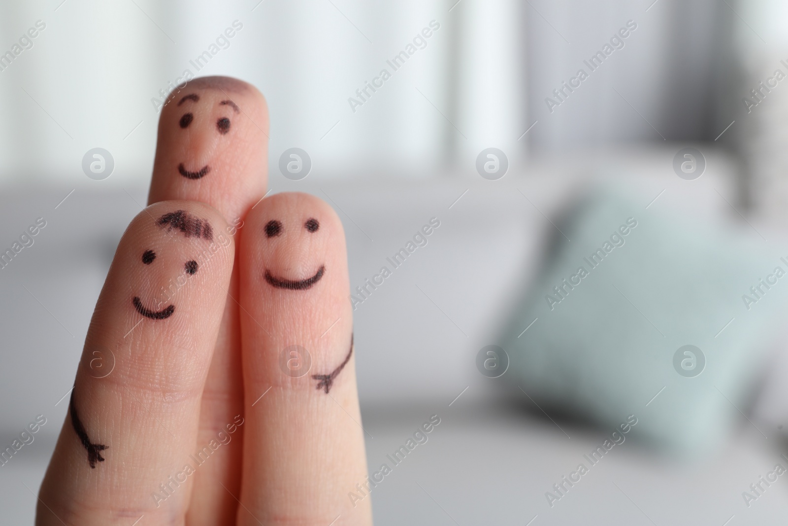 Photo of Three fingers with drawings of happy faces on blurred background, space for text