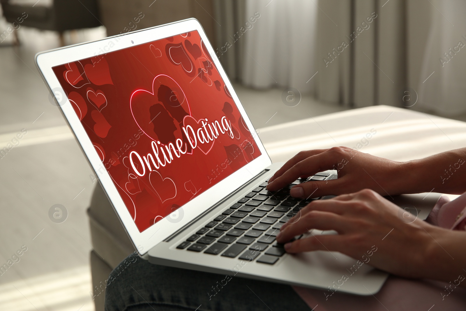 Image of Woman visiting dating site via laptop indoors, closeup