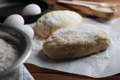 Photo of Raw dough, eggs and flour on wooden table. Cooking ciabatta