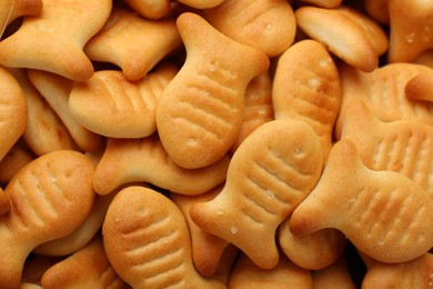 Delicious goldfish crackers as background, closeup view