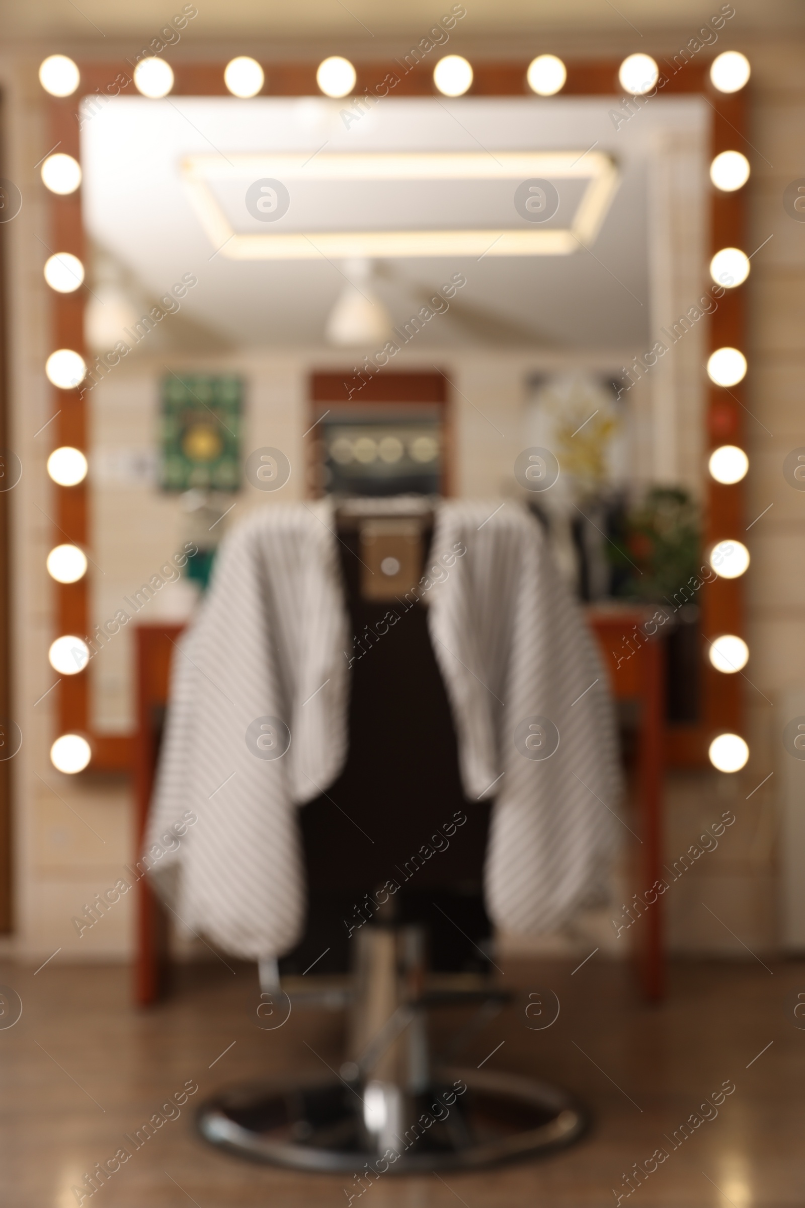 Photo of Blurred view of hairdressing salon with large mirror and chair