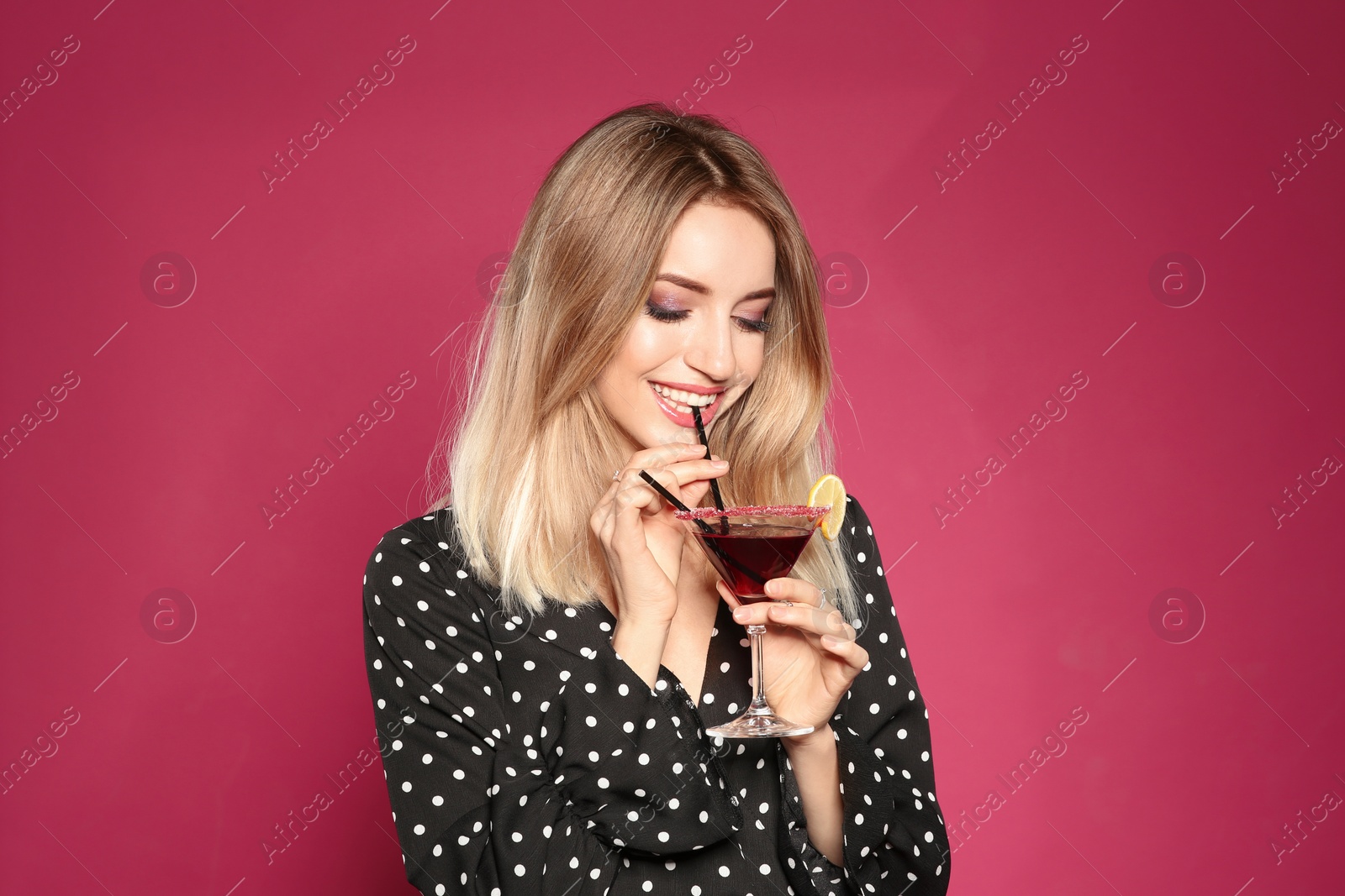 Photo of Beautiful young woman with glass of martini cocktail on color background