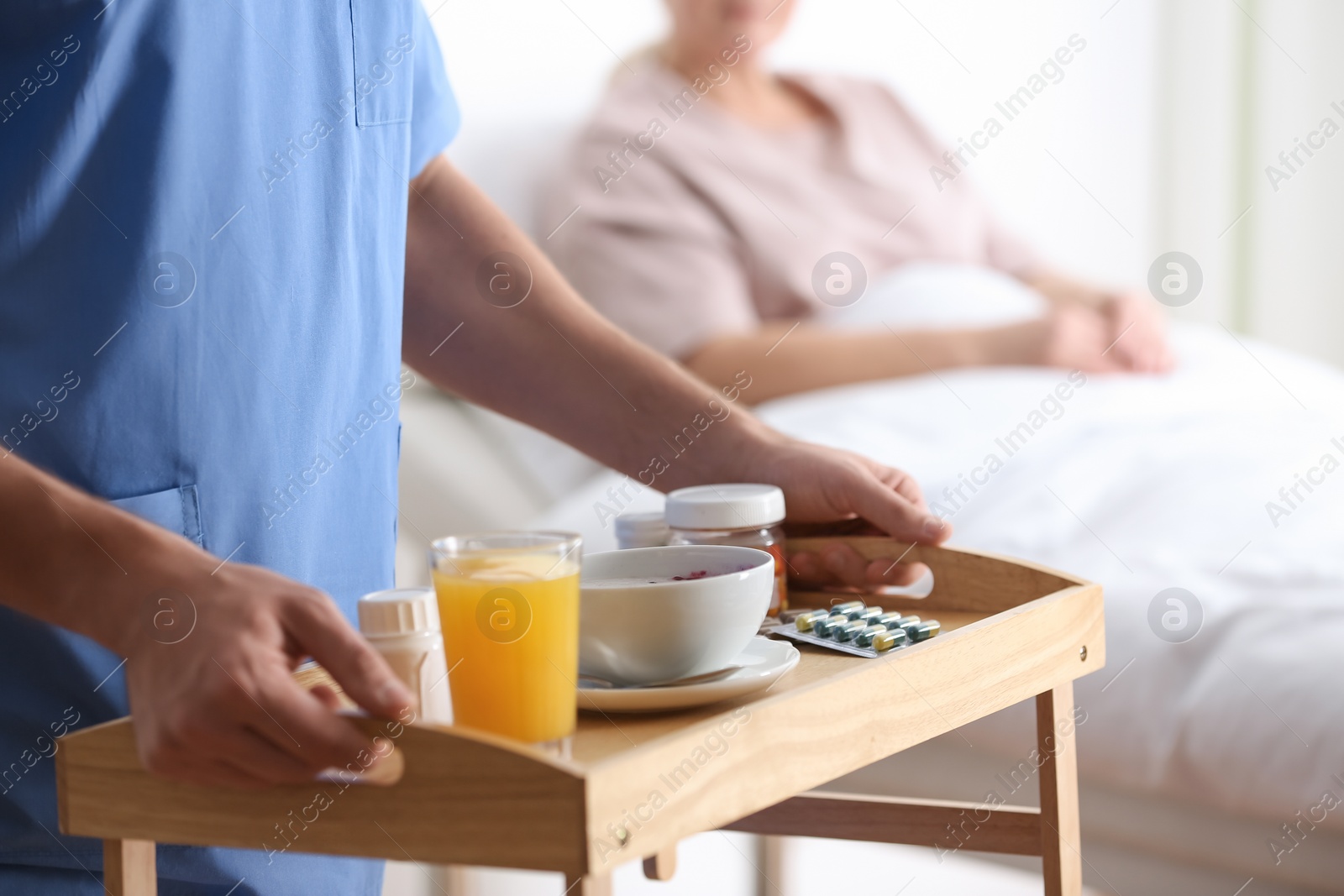 Photo of Male nurse bringing food and medicine for patient in hospital ward, closeup. Doctor's prescription