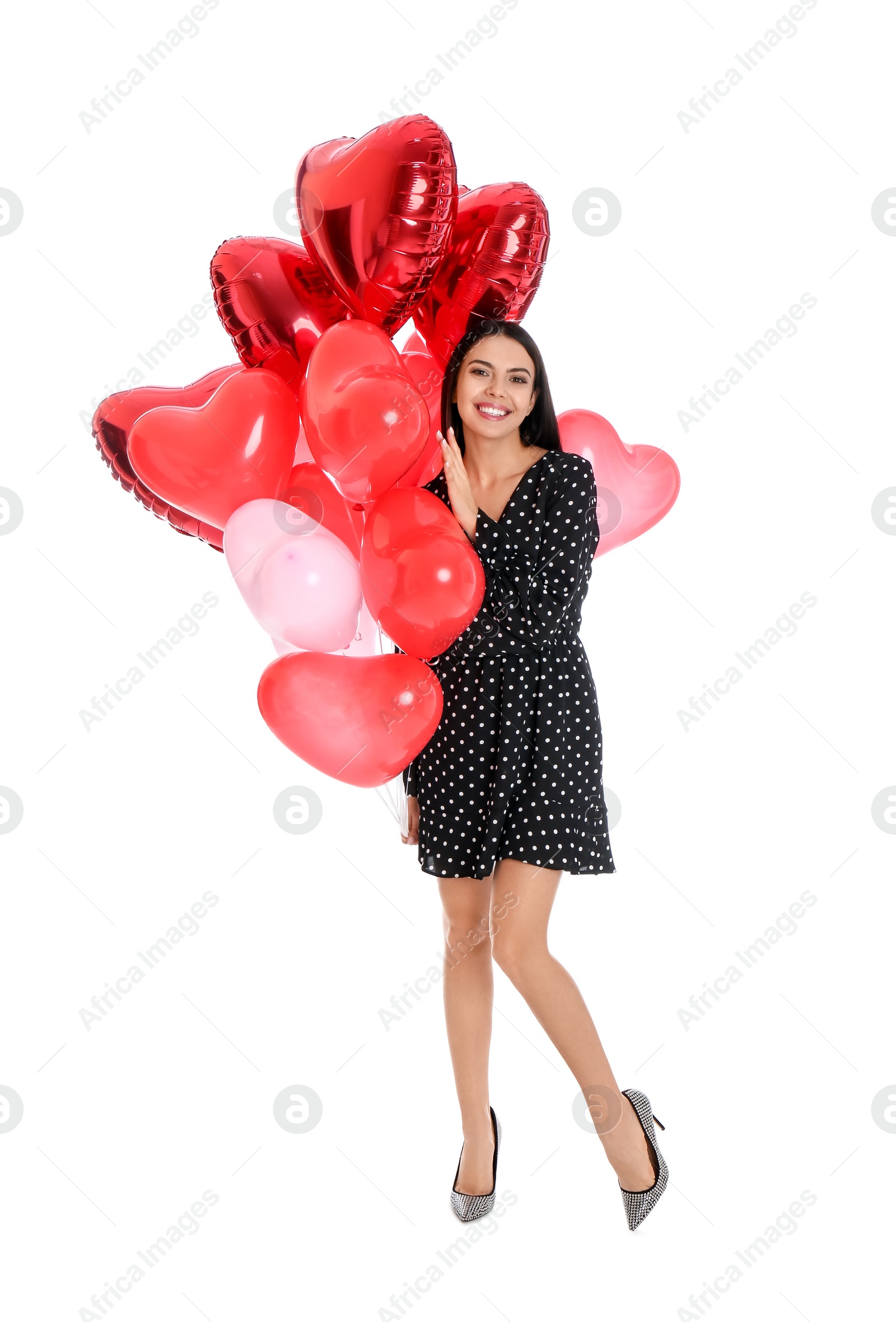 Photo of Beautiful young woman with heart shaped balloons isolated on white. Valentine's day celebration