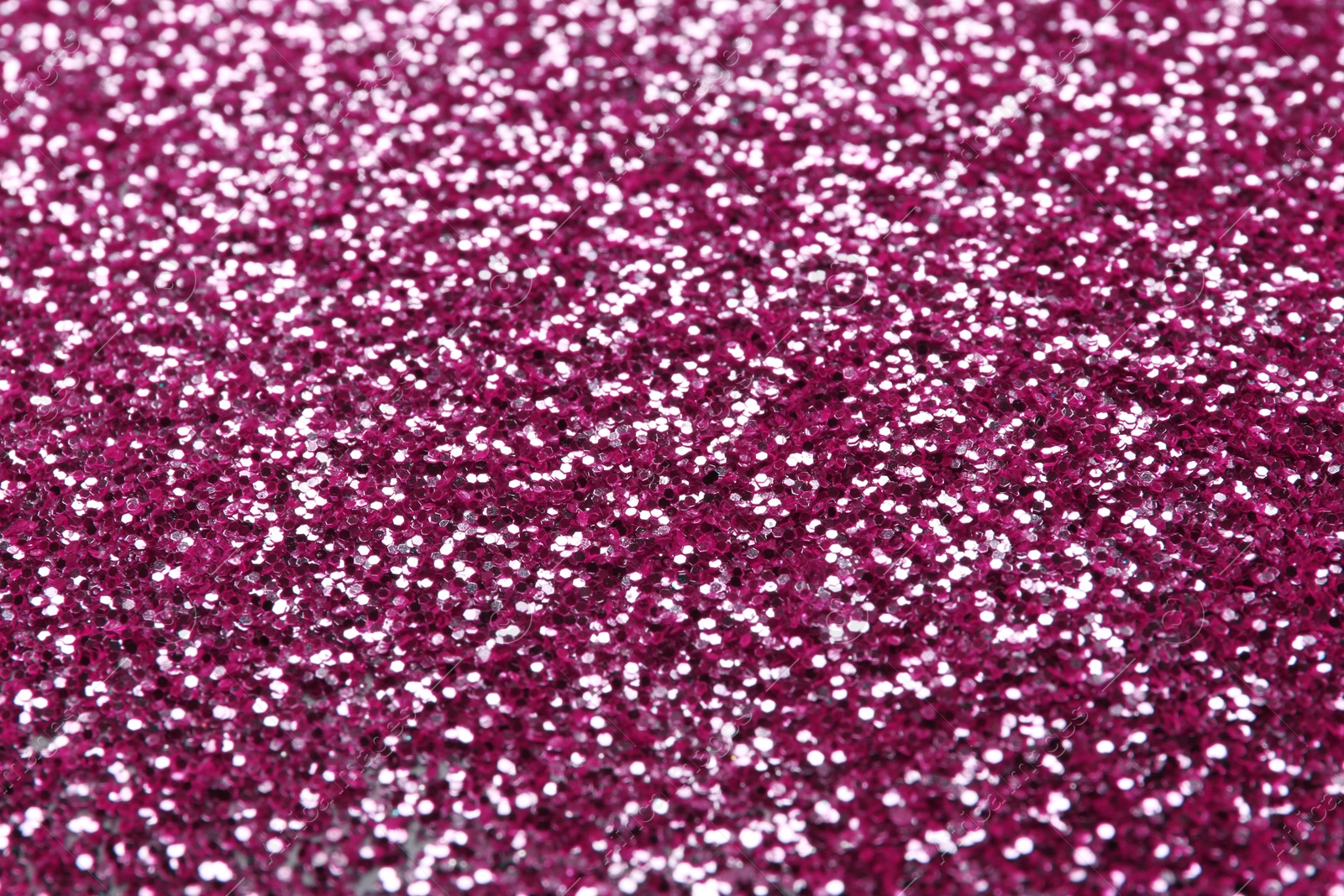 Photo of Closeup view of sparkling pink glitter background