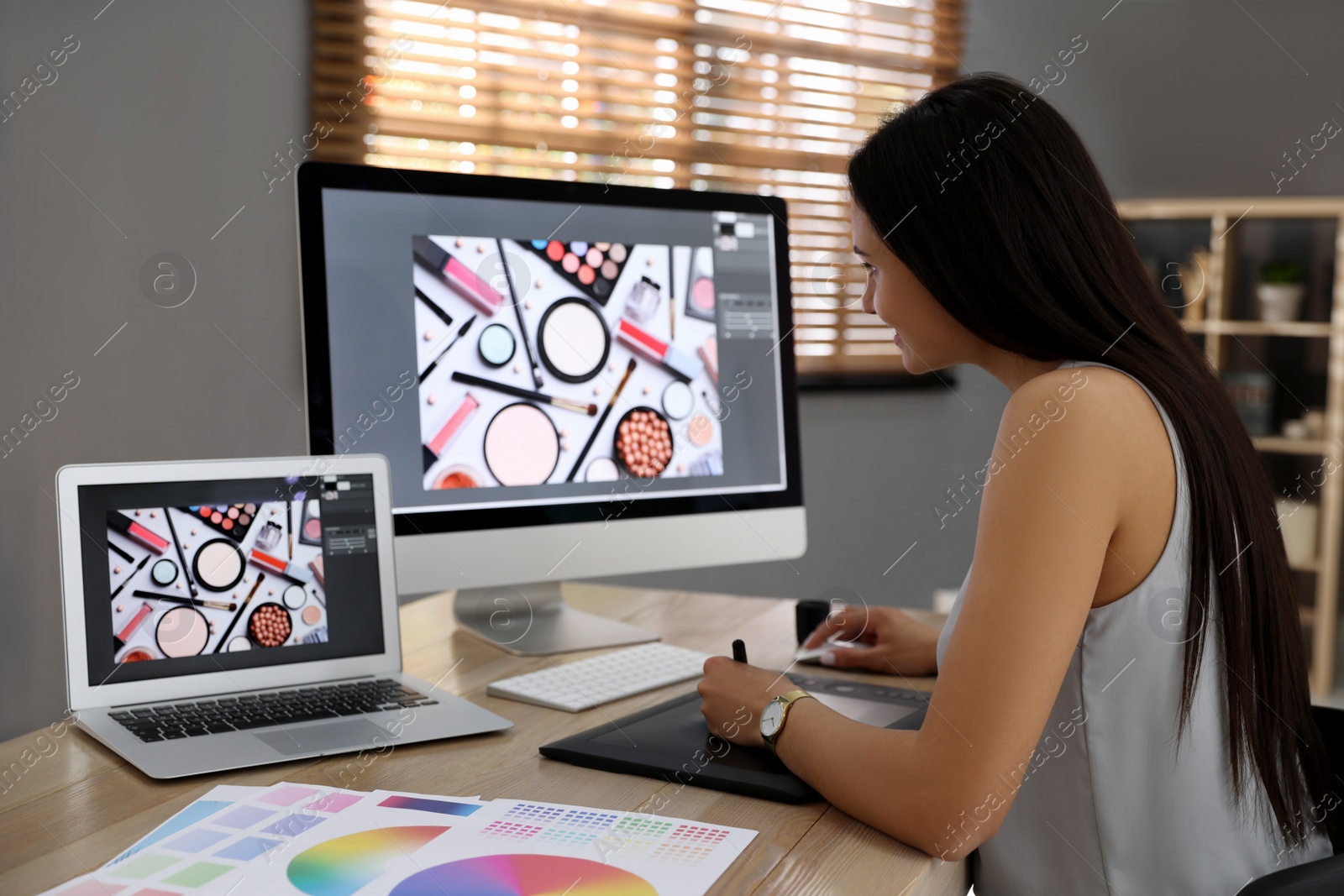 Photo of Professional retoucher working on computer in office