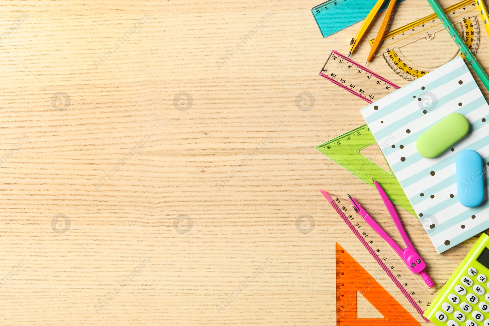 Photo of Set of colorful stationery on wooden table, flat lay with space for text. Teacher's Day