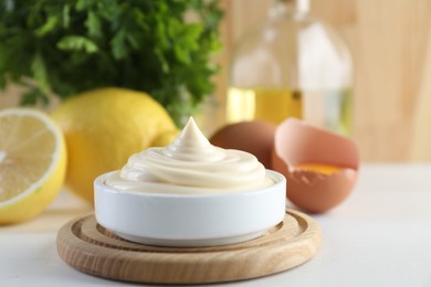 Photo of Fresh mayonnaise sauce in bowl on white wooden table, closeup