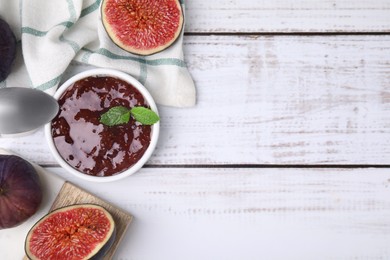 Tasty sweet fig jam and fruits on white wooden table, flat lay. Space for text