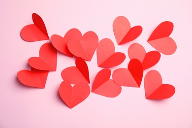 Small paper hearts on color background