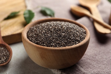 Chia seeds in bowl on table, closeup