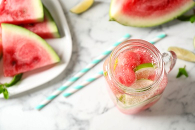 Photo of Tasty refreshing watermelon drink on marble table, above view