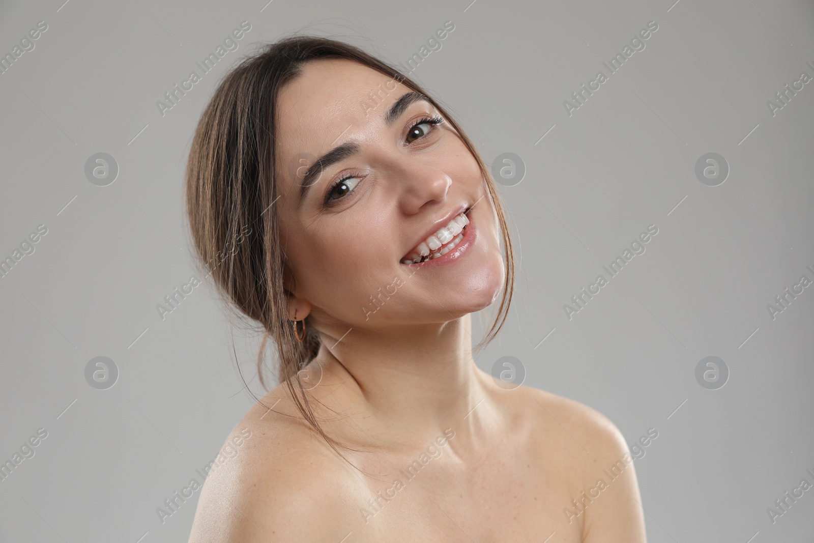 Photo of Portrait of beautiful woman on grey background