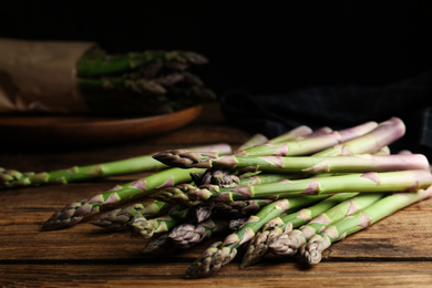 Fresh raw asparagus on wooden table, closeup