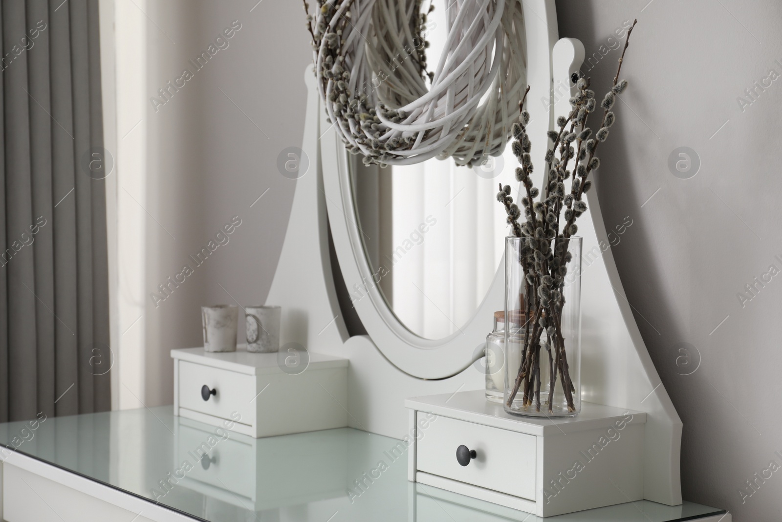 Photo of Elegant dressing table decorated with pussy willow branches indoors