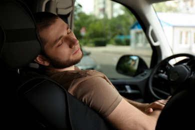 Photo of Tired man sleeping in his modern car