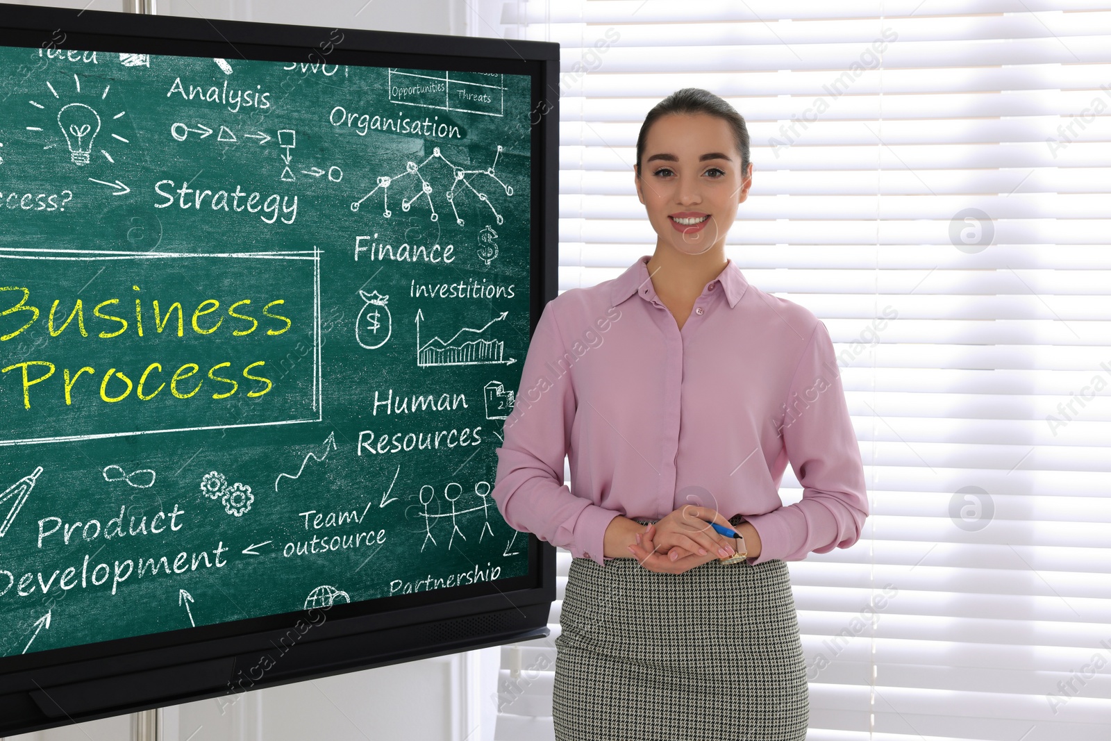 Photo of Business trainer near interactive board in meeting room