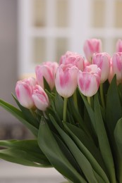 Photo of Beautiful bouquet of fresh pink tulips in kitchen, closeup