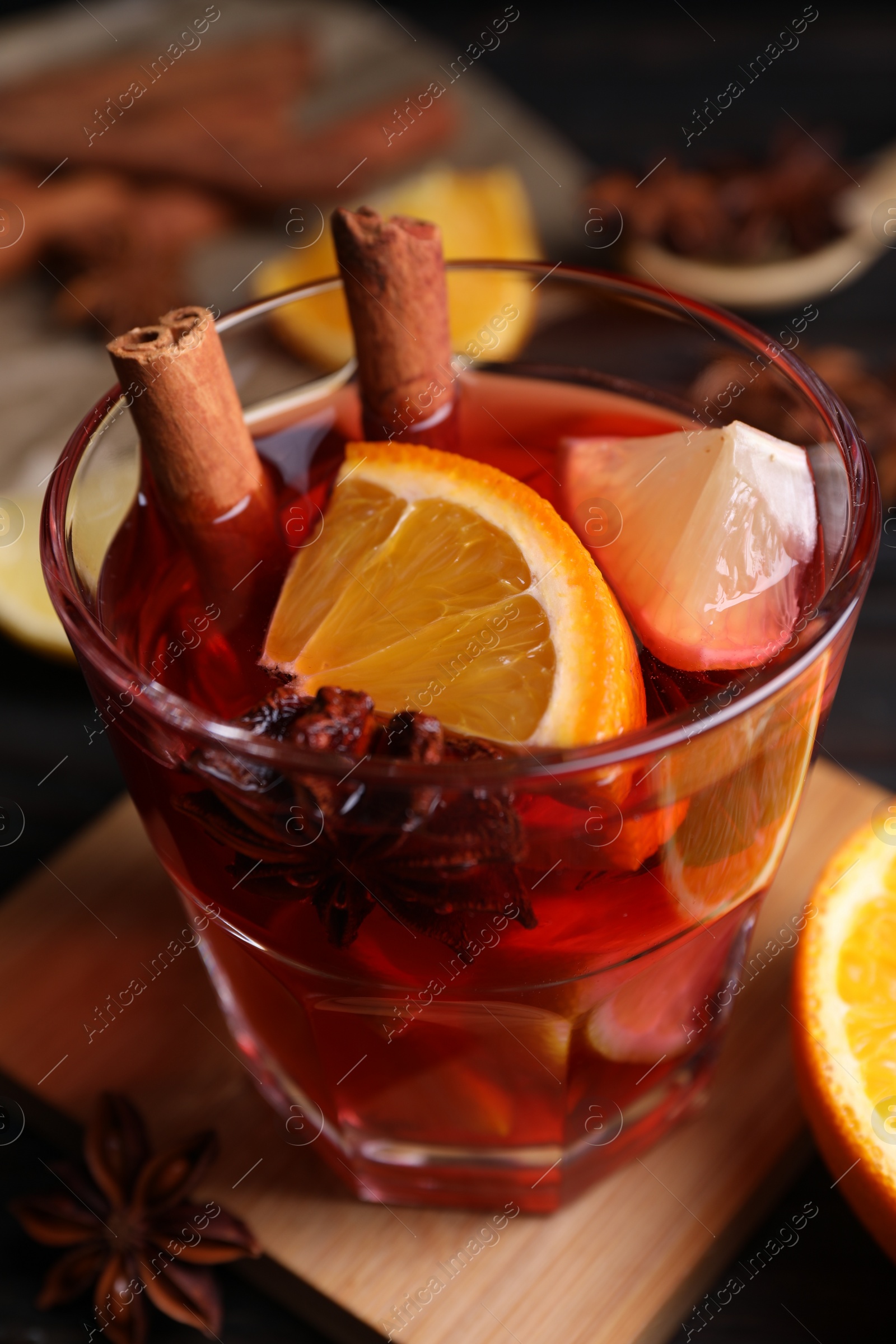 Photo of Glass of aromatic punch drink on table, closeup