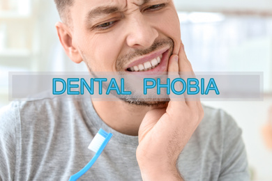 Image of Dental phobia concept. Man suffering from toothache indoors