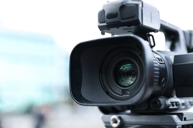 Photo of Professional video camera on city street, closeup