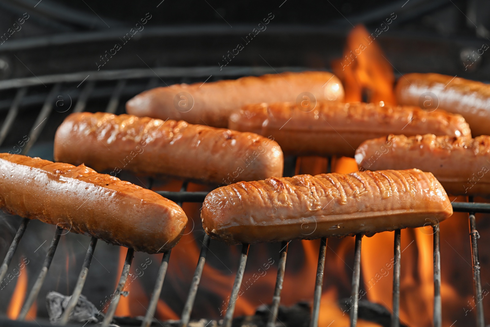 Photo of New modern barbecue grill with tasty sausages, closeup