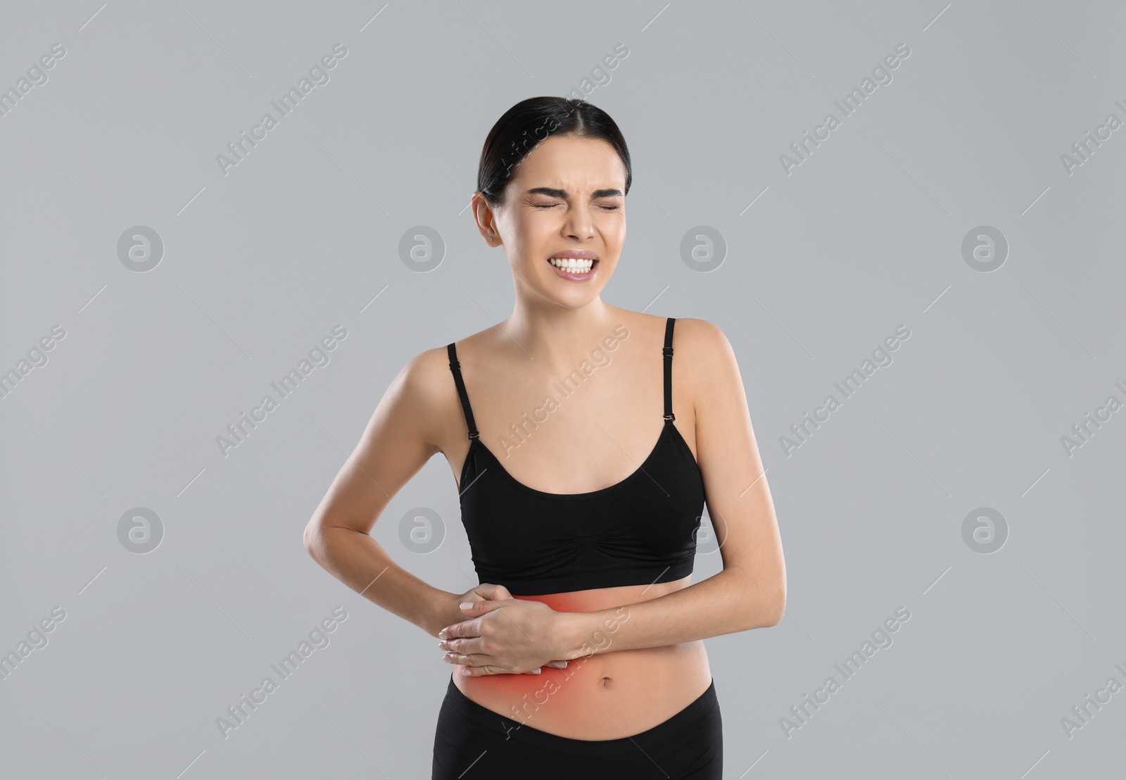 Photo of Woman suffering from liver pain on grey background