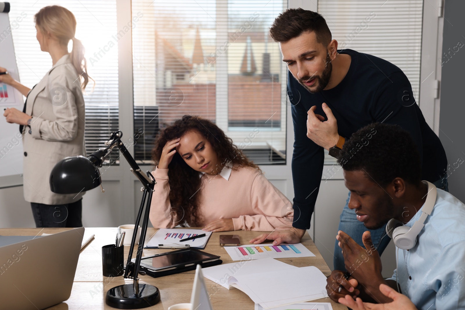 Photo of Team of employees working together in office. Startup project