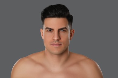 Handsome man after shaving on grey background