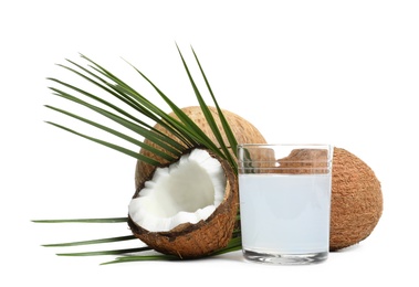 Photo of Glass of coconut milk and nuts on white background