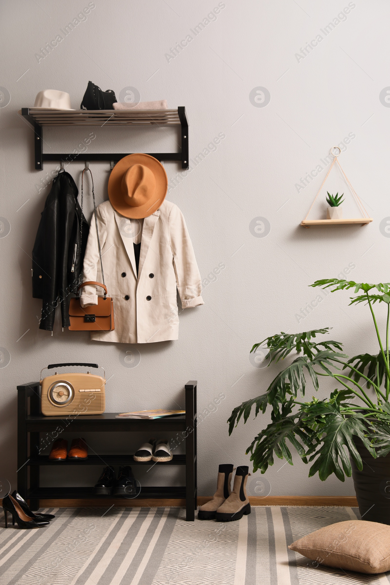 Photo of Hallway interior with stylish furniture, clothes and accessories